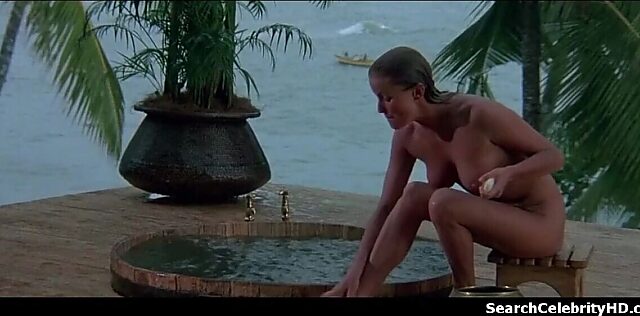 Milf Bo Derek gives a naughty handjob with her small tits out
